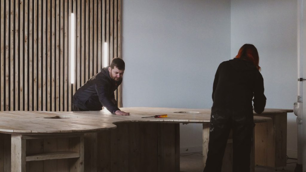 Two carpenters from BB designs, building a large wooden table