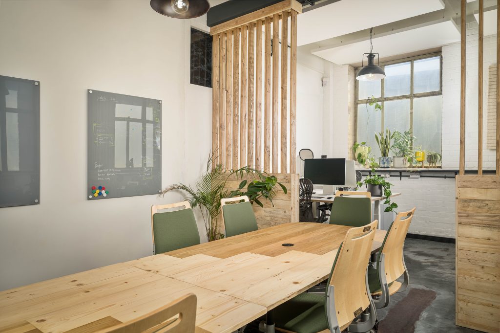 Moveable reclaimed timber tables with refurbished chairs and timber dividers