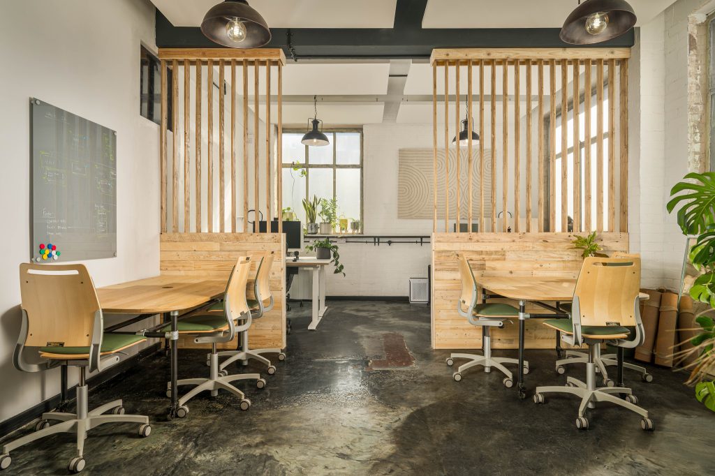 Modular reclaimed timber table with refurbished chairs and reclaimed wood dividers