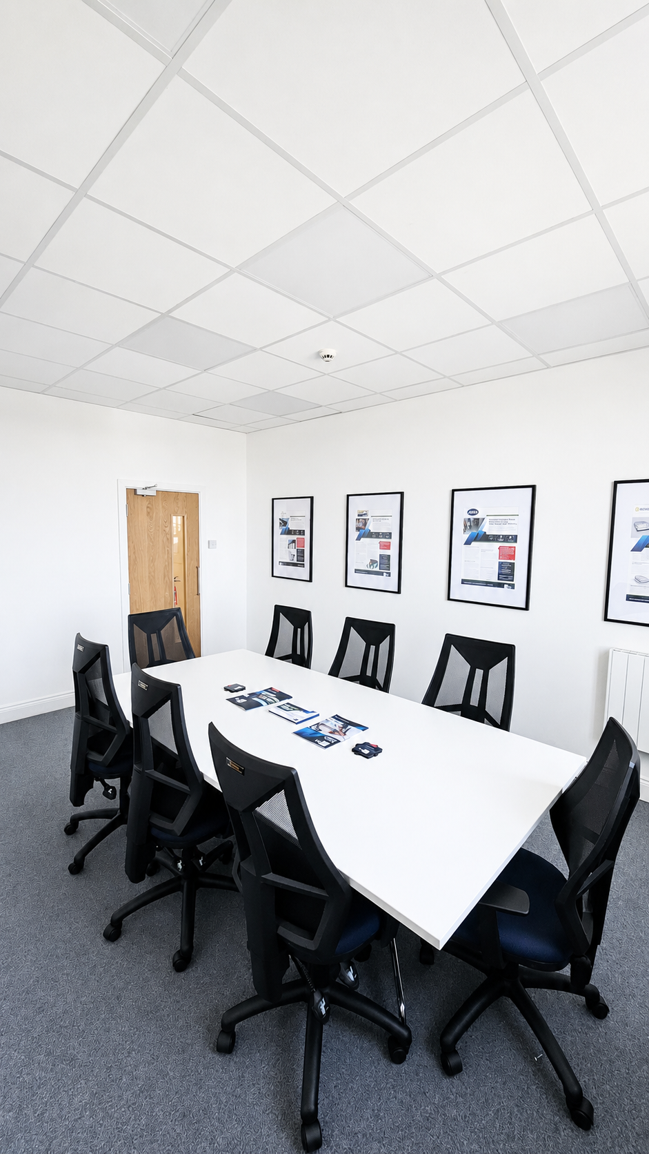 Refurbished commercial meeting room with new carpet and fire door