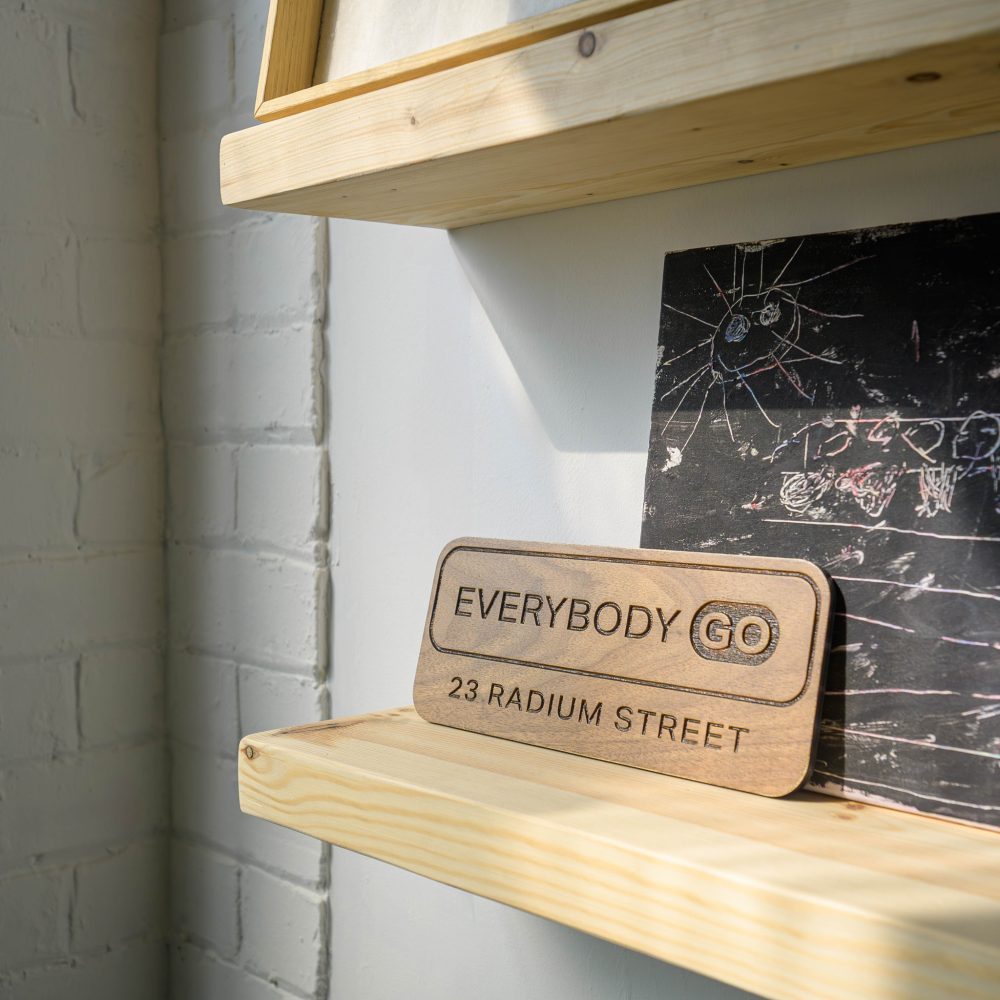 Reclaimed timber shelving with custom wooden signage